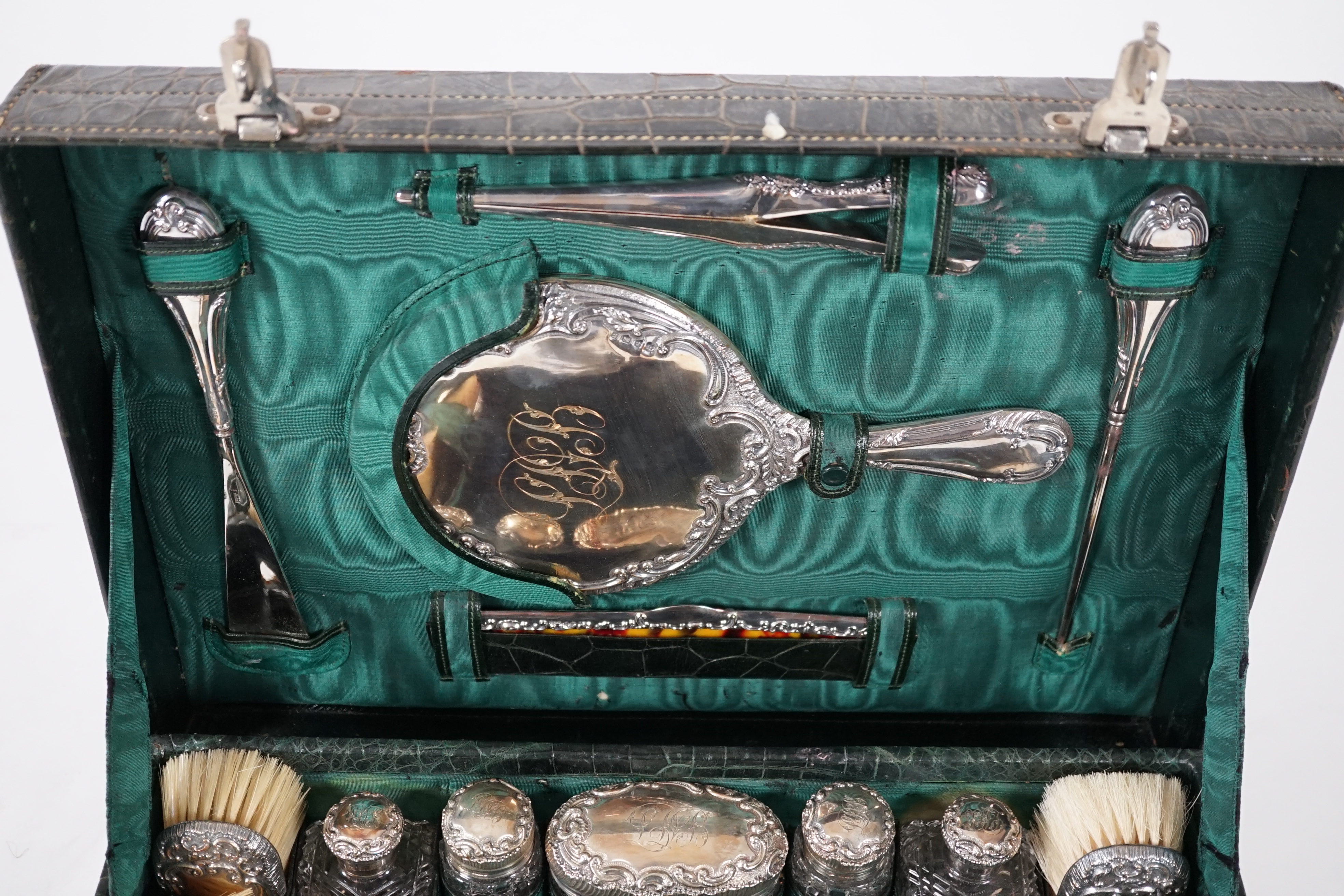 A George V green crocodile toilet case, 46cm x 33cm x 18cm